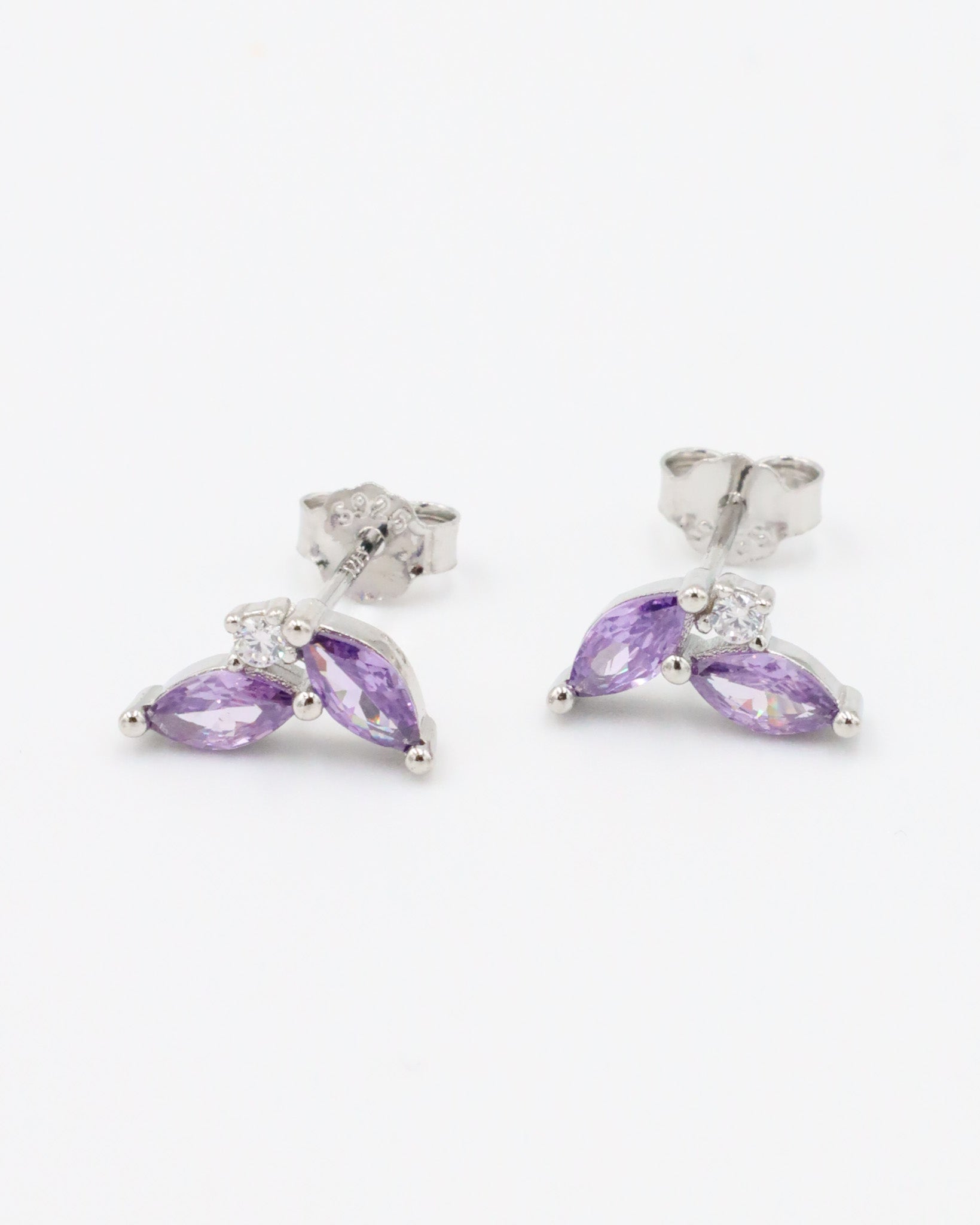 Pair of sterling silver Eliza Purple Silver stud earrings featuring marquise-cut purple zirconia stones and cubic zirconia accents.