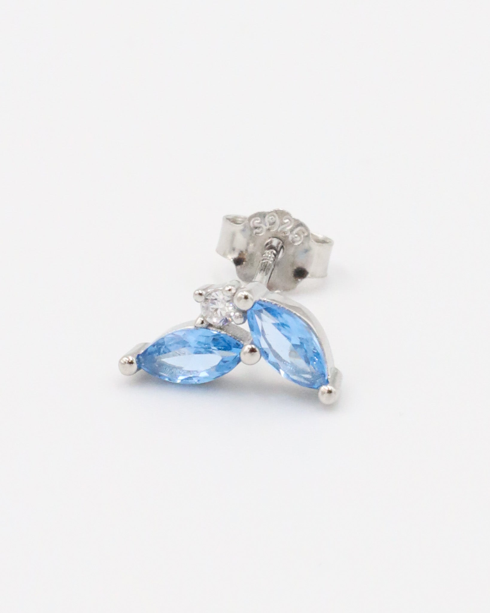 Close-up view of the left Eliza Blue Silver earring with two blue zirconia stones in sterling silver.