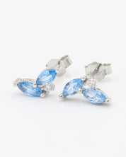 A pair of sterling silver stud earrings featuring blue zirconia stones in a marquise cut, set elegantly on silver.