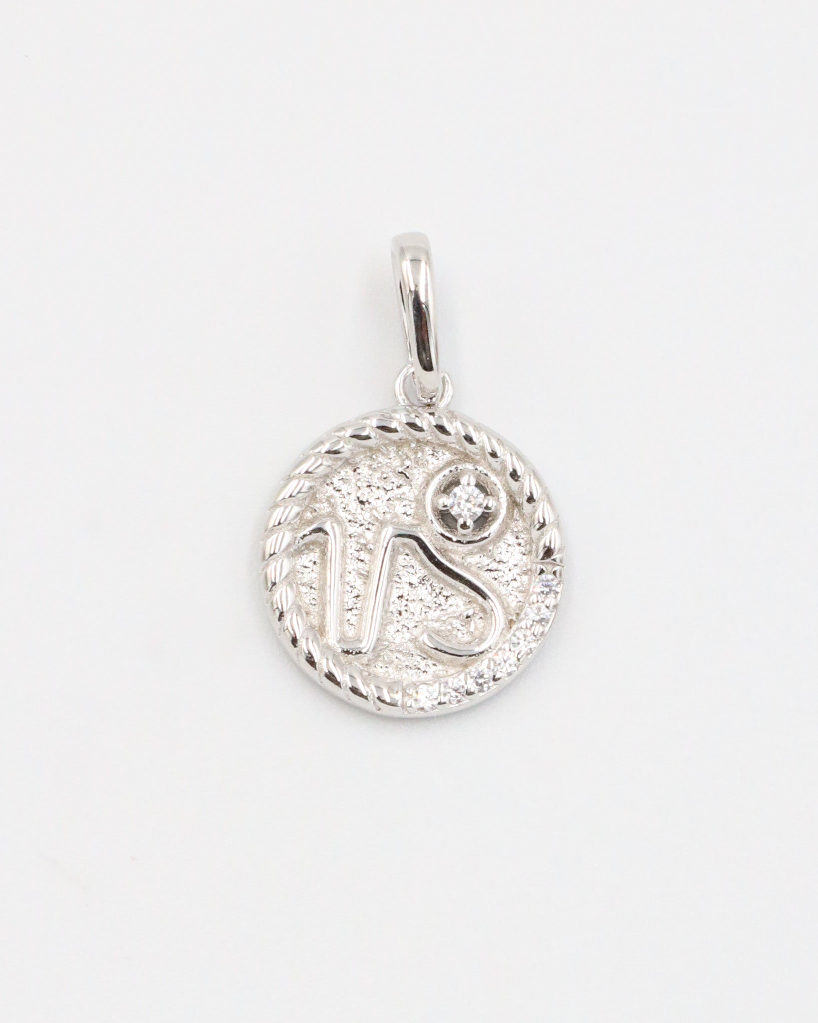 Capricorn zodiac silver pendant in rhodium-plated sterling silver with sparkling zirconia detail.